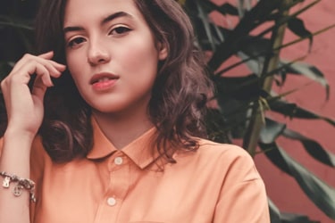 a woman wearing an orange shirt
